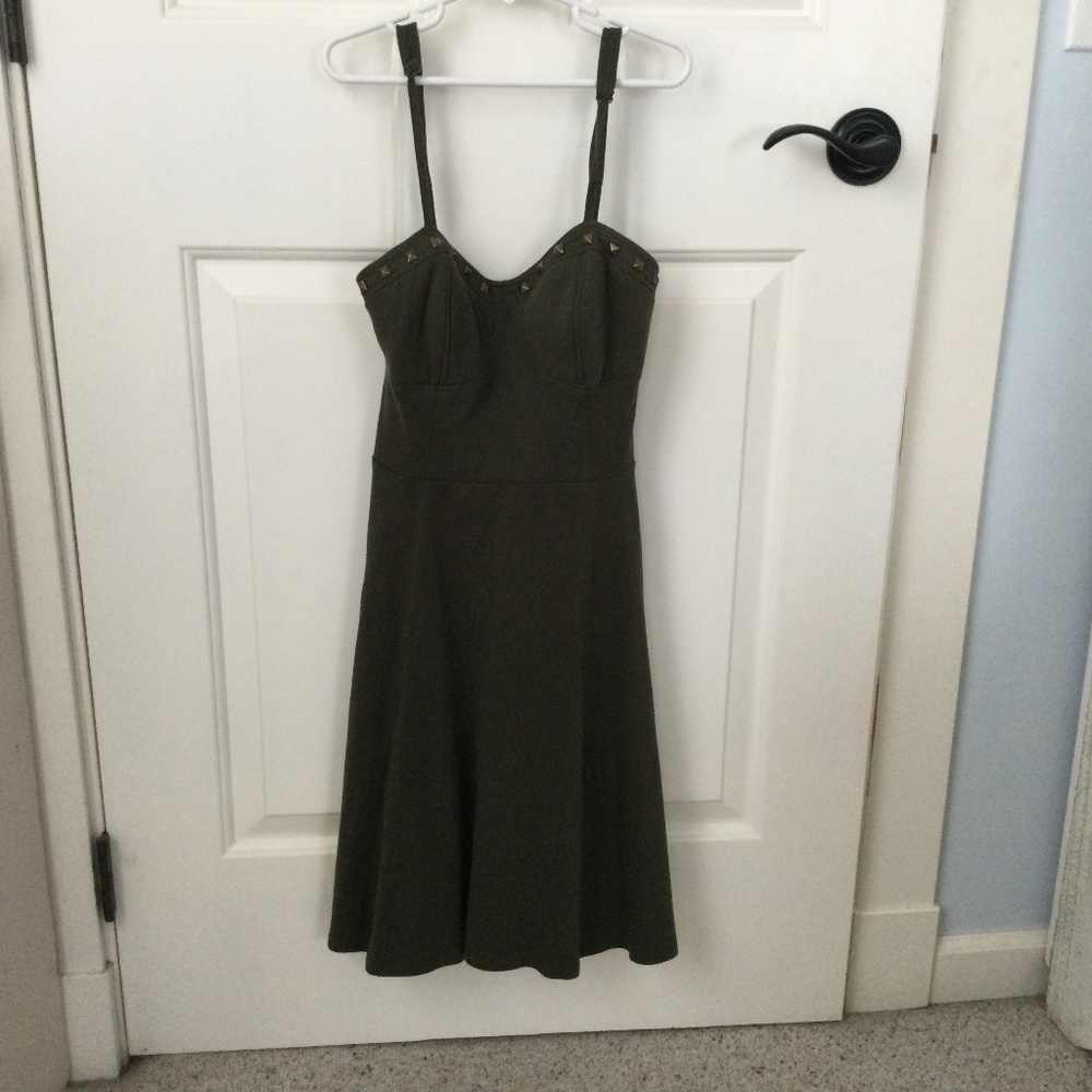 Olive, lightweight knit dress with straps, fitted top and cute metallic detail.